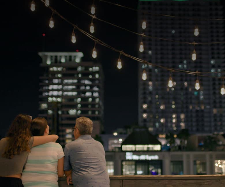Family hanging out together with daughter hugging mother